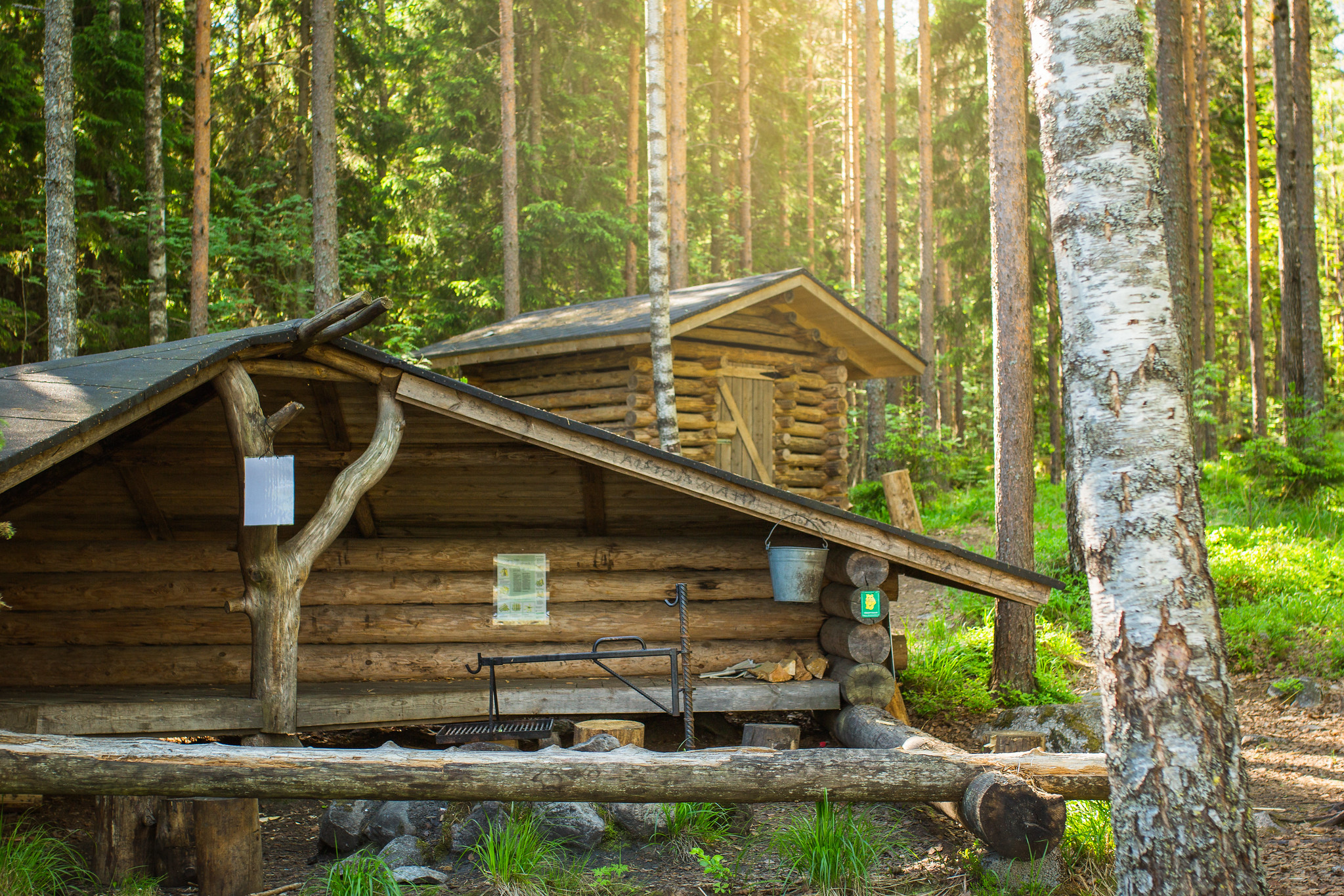 A lean-to shelter with a woodshed behind it.