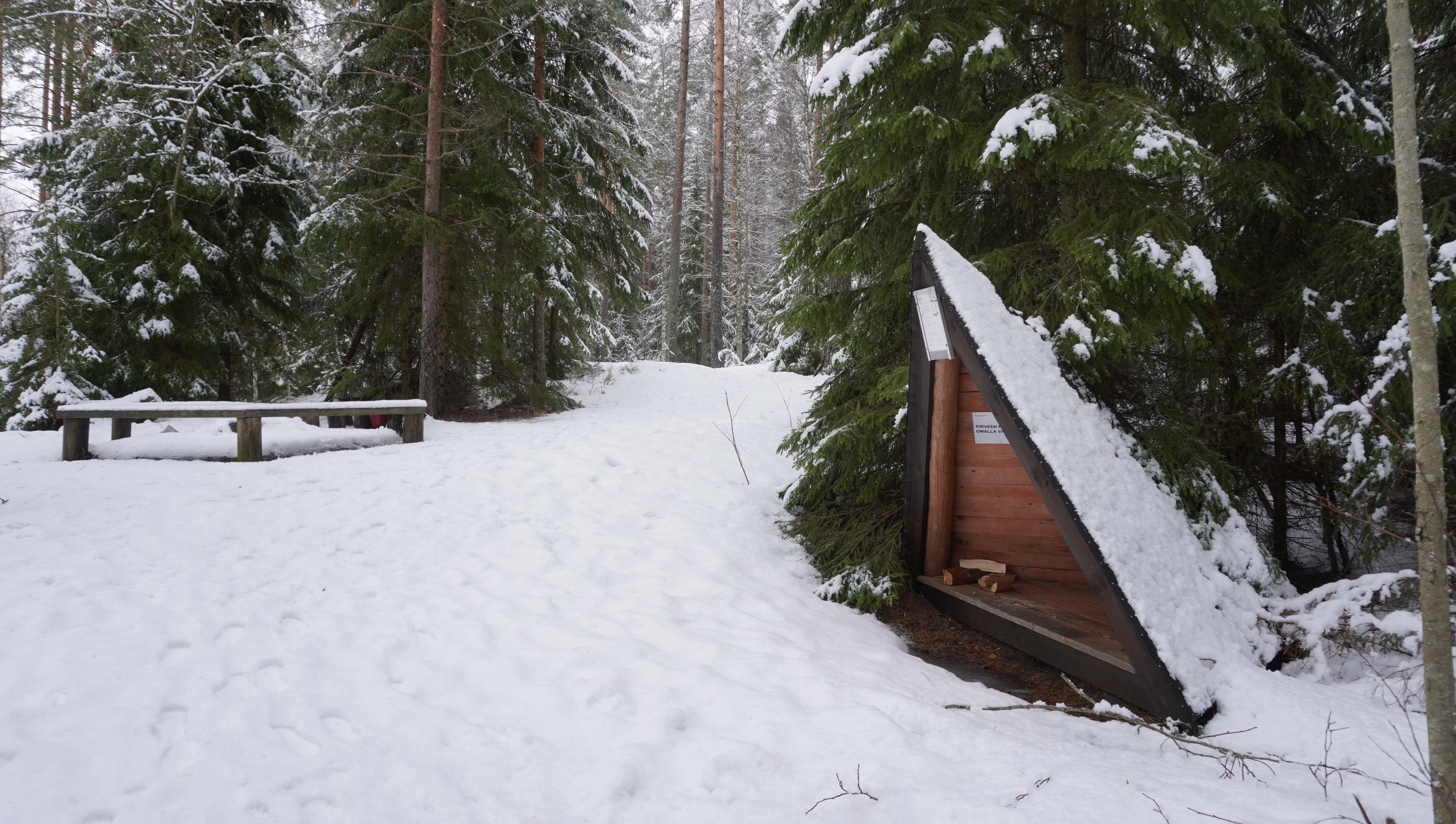 There is a small triangular shelter next to the campfire site.