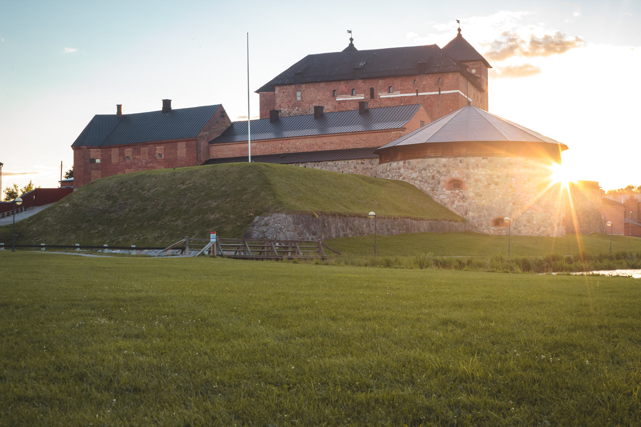 Old medieval castle next to a lake.