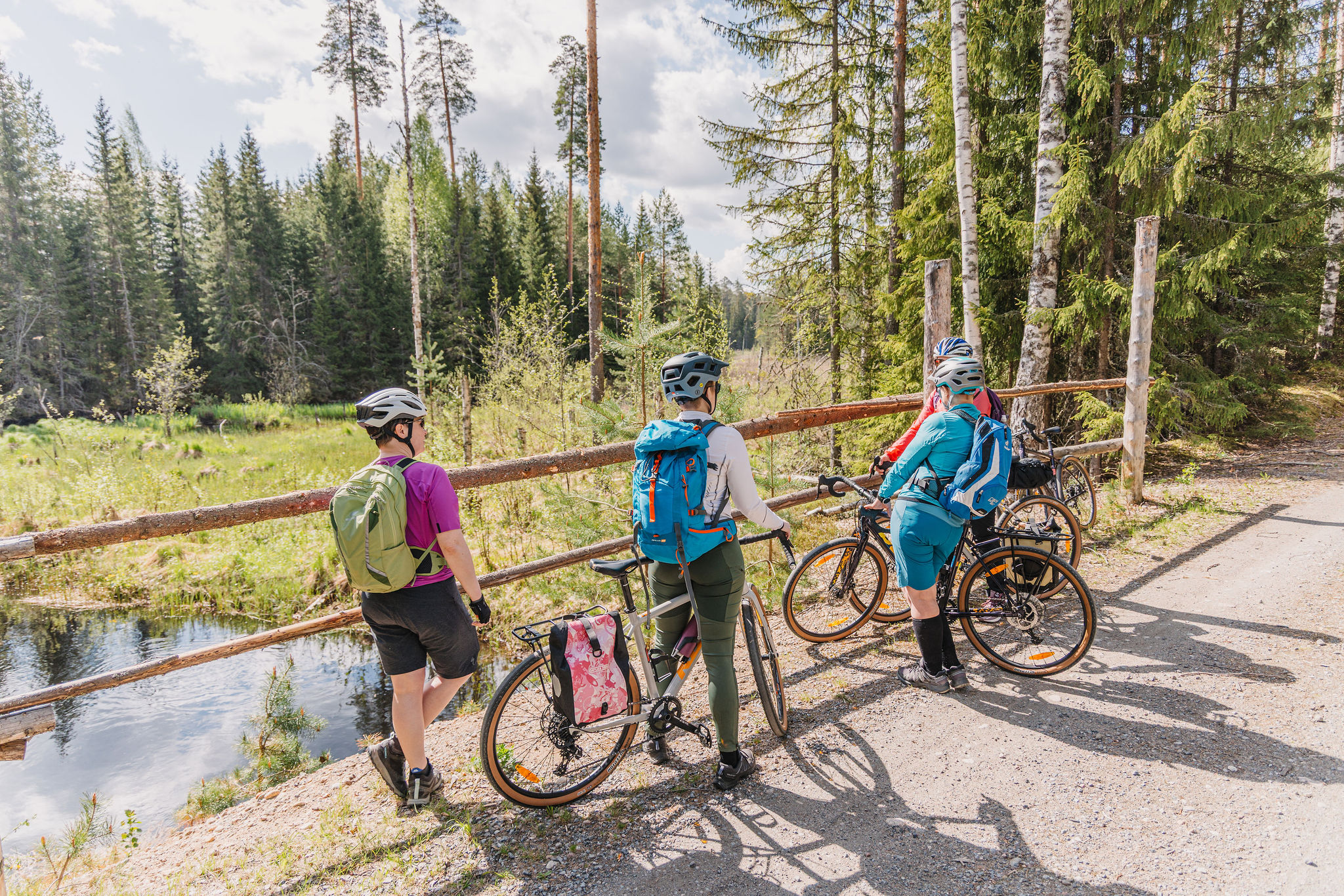 Women have stopped with their bicycles to admire the waterways.