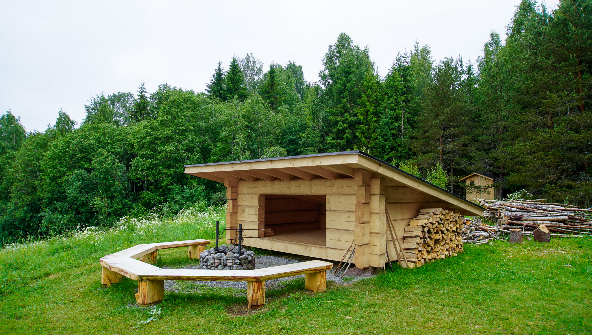 The shelter is located at the edge of the forest.