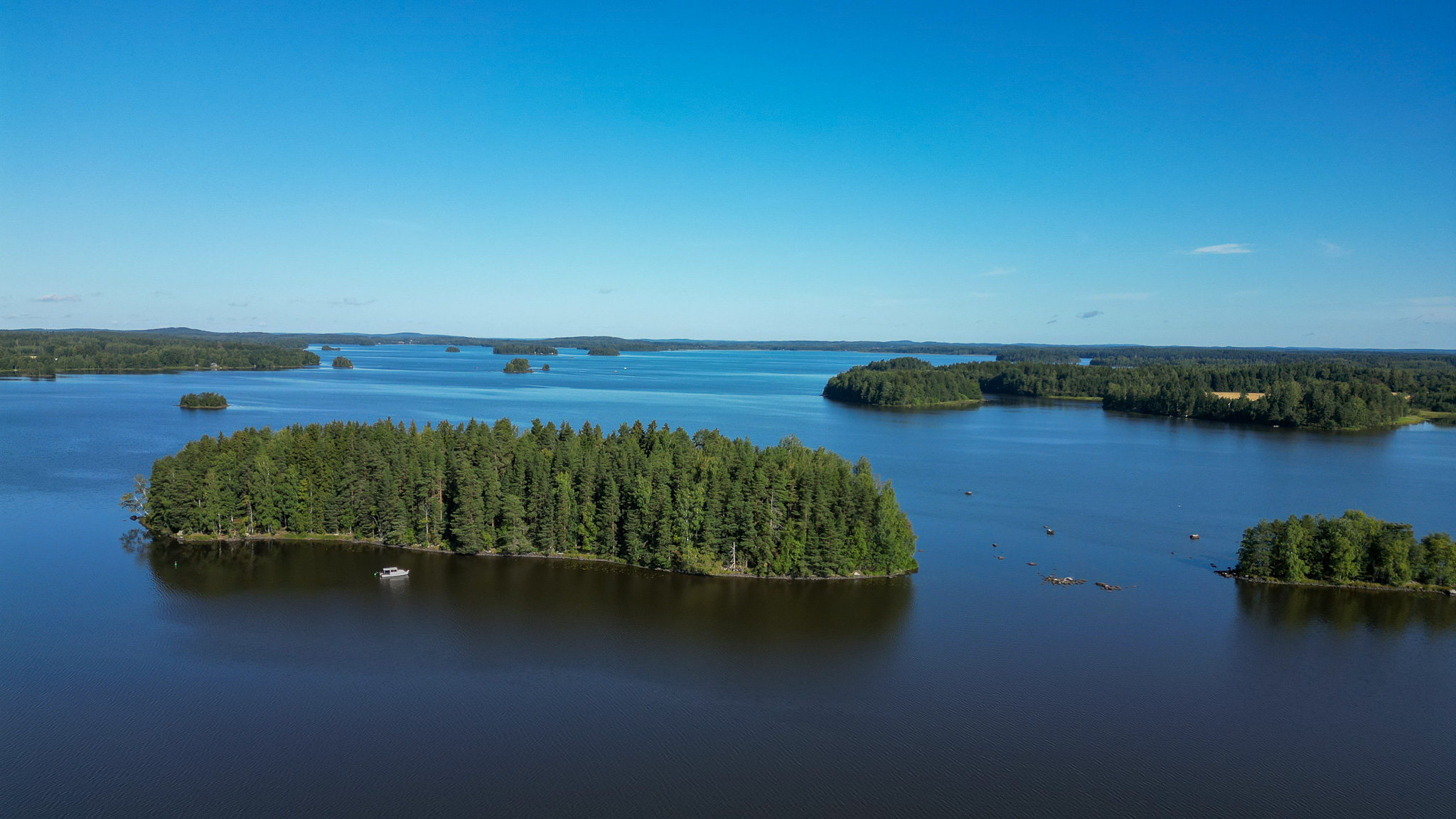 An forest island surrounded by a lake.
