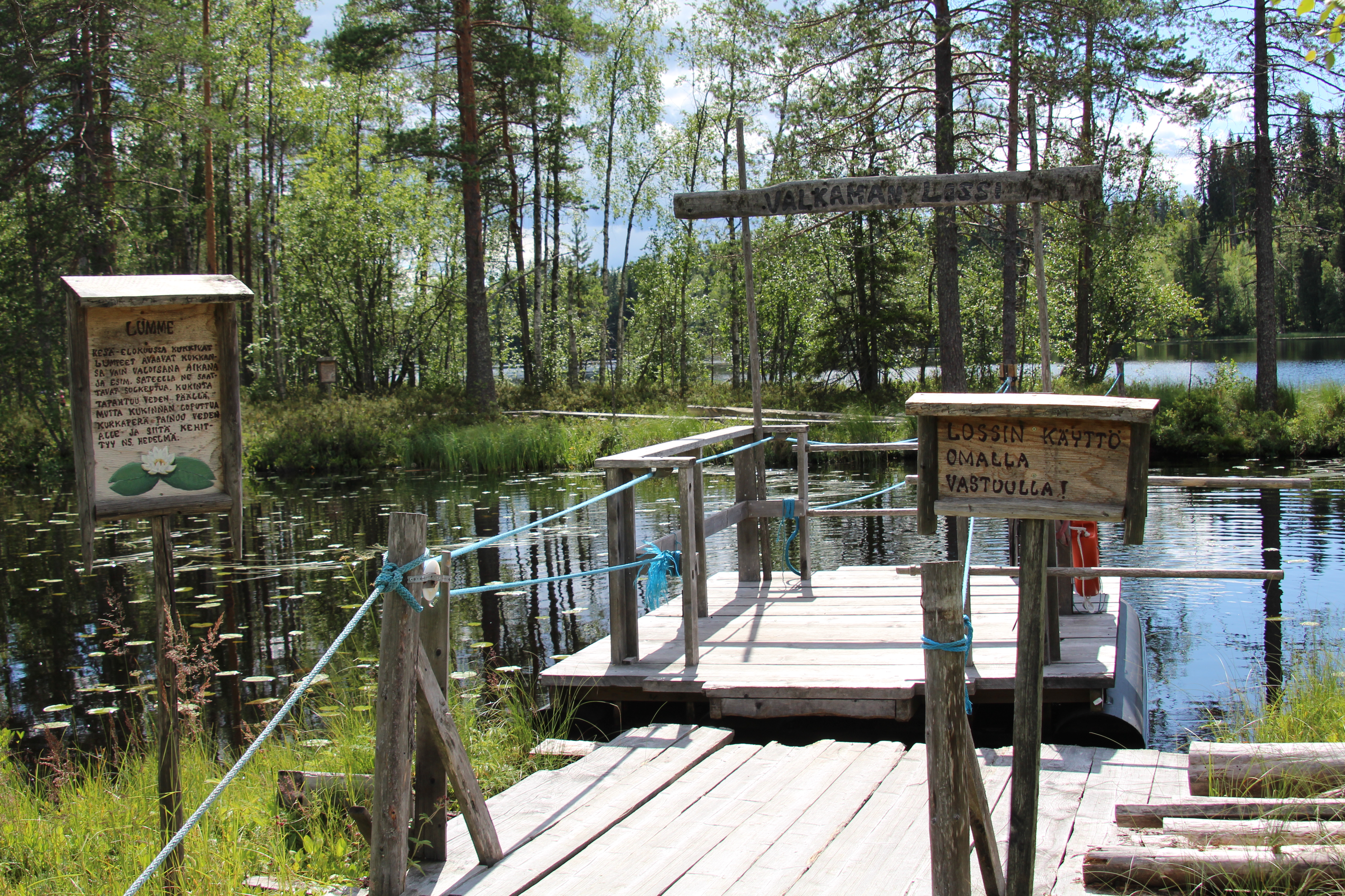 A rope ferry to a small island surrounded by a lake